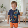 Young boy in Caroagi rocket t-shirt and orange shorts set enjoying active play